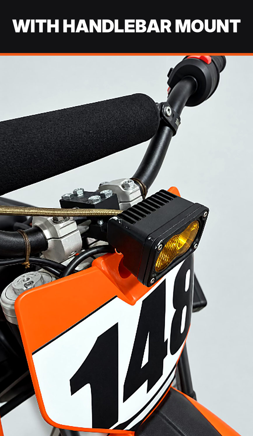 Yellow lens Baja light on the handlebar mount option, installed on an orange dirt bike number plate